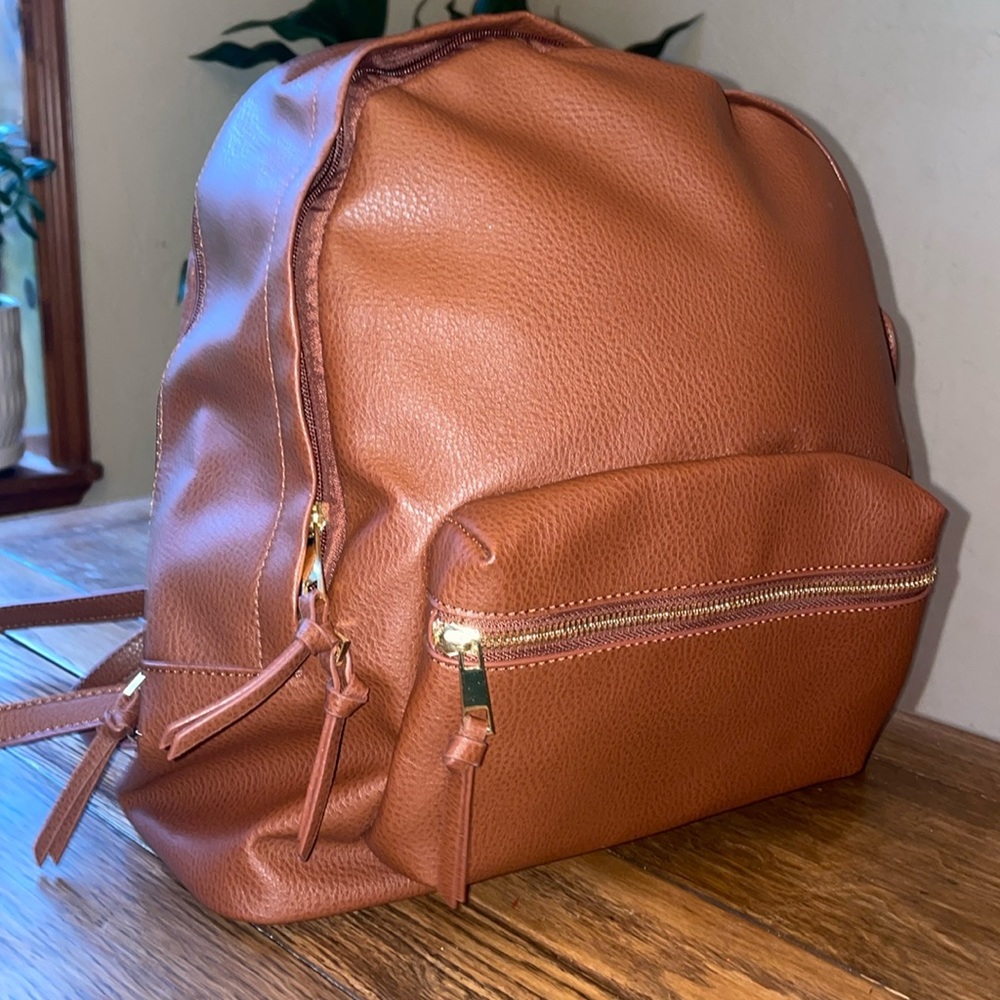JustFab - new without tags perfect condition travel backpack. Brown and gold.